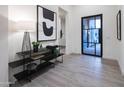 Elegant foyer featuring stylish decor, tile flooring, and a modern steel and glass front door at 23880 N 127Th St, Scottsdale, AZ 85255