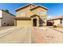 Charming two-story home with a two-car garage, landscaped front yard, and tile roof accents at 2546 E Camellia Dr, Gilbert, AZ 85296