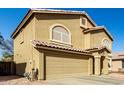 Tan two-story home featuring a two-car garage and tile roof at 2546 E Camellia Dr, Gilbert, AZ 85296