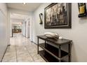 Inviting hallway with neutral tile flooring, a console table, and stylish wall decor at 2678 S 172Nd Dr, Goodyear, AZ 85338