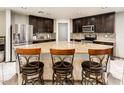 Gourmet kitchen with a large island, granite countertops, stainless steel appliances, and bar stool seating at 2678 S 172Nd Dr, Goodyear, AZ 85338