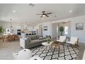 Spacious open-concept living room seamlessly connecting the dining and kitchen areas, with modern decor at 33417 N 142Nd Way, Scottsdale, AZ 85252