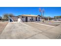 Charming single-story home with a spacious driveway and low-maintenance front yard at 350 S Thunderbird Dr, Apache Junction, AZ 85120