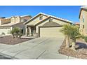 Beige single-story home featuring low maintenance landscaping and a two car garage at 4050 E Agave Rd, Phoenix, AZ 85044