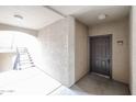 Hallway leading to a door with unit number 2095 and stairs with natural light at 5401 E Van Buren St # 2095, Phoenix, AZ 85008