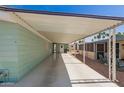 Extended carport offers covered parking and leads to the home's entrance at 5402 E Mckellips Rd # 326, Mesa, AZ 85215