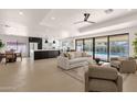 Open-concept living room featuring modern furnishings and sliding glass doors to the pool at 6759 E Aire Libre Ln, Scottsdale, AZ 85254