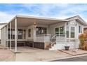 Attractive mobile home with covered parking, inviting front porch, and well-kept exterior at 7750 E Broadway Rd # 843, Mesa, AZ 85208