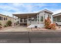 Charming mobile home featuring a covered porch, well-maintained landscaping, and a cozy exterior at 7750 E Broadway Rd # 843, Mesa, AZ 85208