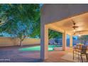 Inviting backyard featuring a covered patio, outdoor seating, and a refreshing in-ground pool at 7826 W Kerry Ln, Glendale, AZ 85308