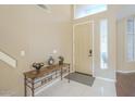 Inviting home entryway featuring tile floors, a console table, and a high ceiling at 908 E Mountain Sage Dr, Phoenix, AZ 85048