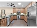 Well-equipped kitchen featuring stainless steel appliances, granite countertops, and tile backsplash at 913 E Tekoa Ave, Gilbert, AZ 85298