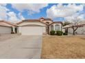 Charming one-story home with desert landscaping, tiled roof, and an attached two-car garage at 9632 W Runion Dr, Peoria, AZ 85382