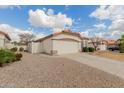 Exterior home showcasing desert landscaping, a tiled roof, and an attached two-car garage at 9632 W Runion Dr, Peoria, AZ 85382