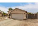 Charming single-story home with a two-car garage, sidewalk and desert landscaping at 9948 N 94Th Ave, Peoria, AZ 85345