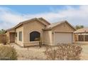 Charming single-story home with desert landscaping and a two-car garage at 9948 N 94Th Ave, Peoria, AZ 85345