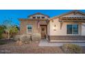 Charming single-story home with stone accents, lush landscaping and a welcoming front entrance at 13346 W Jesse Red Dr, Peoria, AZ 85383