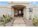 Inviting home entrance featuring a bench, cactus plants, and desert landscaping at 15440 E Mustang Dr, Fountain Hills, AZ 85268