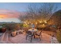 Charming patio with outdoor table setting and picturesque mountain views creates a delightful space for relaxation at 15510 E Sycamore Dr, Fountain Hills, AZ 85268