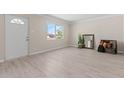 Bright, airy living room with light wood floors, a front door, and ample natural light at 171 W Tulsa St, Chandler, AZ 85225