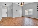 Spacious living room with tile floors, ceiling fan and high ceilings at 1717 E Sandra Ter, Phoenix, AZ 85022