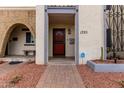 Close-up of the front door with security gate and desert landscaping at 1725 W Marlette Ave, Phoenix, AZ 85015