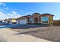 Beautiful single-story home with a three-car garage and low maintenance landscaping at 17735 W Brown St, Waddell, AZ 85355