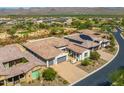 An aerial image depicts the tile roofs of houses, paved driveways, and native landscaping in the surrounding community at 18016 E Wolf Tree Ln, Rio Verde, AZ 85263