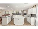 Open-concept kitchen featuring a large island with a modern design and lots of storage space at 1974 E Vinedo Ln, Tempe, AZ 85284