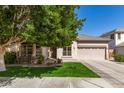 Charming single story home with a well-manicured lawn, desert landscaping and a two car garage at 2450 E Glass Ln, Phoenix, AZ 85042