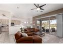 Inviting living room with sliding glass doors, sleek ceiling fan, and a seamless open-concept design at 2450 E Glass Ln, Phoenix, AZ 85042