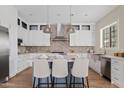 Bright kitchen with a central island, modern appliances, and stylish pendant lighting at 2457 W Phillips Rd, Queen Creek, AZ 85144