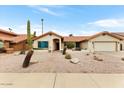 Charming home with desert landscaping, a red tile roof, and an attached two-car garage at 2923 N 63Rd St, Mesa, AZ 85215