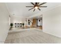 Spacious living room with carpet, neutral walls, and tile floors leading to other rooms at 2923 N 63Rd St, Mesa, AZ 85215