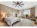 Spacious main bedroom with a ceiling fan, neutral walls, and a step-up to a private outdoor space at 2923 N 63Rd St, Mesa, AZ 85215
