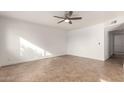 Bright, airy living room with tiled floors, ceiling fan, neutral walls, and access to hallway at 3027 S Clementine Dr, Tempe, AZ 85282