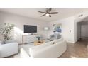 Bright living room featuring a neutral color palette, modern furnishings, and a ceiling fan at 3027 S Clementine Dr, Tempe, AZ 85282