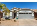 Charming single-story home featuring a well-maintained front yard and a two-car garage at 3284 W Five Mile Peak Dr, San Tan Valley, AZ 85144