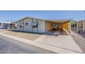 Single-story home with attached carport, offering shade and protection at 3330 E Main St # 7, Mesa, AZ 85213