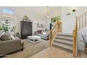 Bright living room with high ceilings, neutral decor, and carpeted stairs at 3336 E Linda Ct, Gilbert, AZ 85234