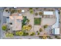 Expansive aerial view of a residence with multiple structures, mature trees and landscaping on a large desert homesite at 38301 N 15Th Ave, Phoenix, AZ 85086