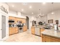 Bright kitchen features knotty alder cabinets, granite countertops and stainless steel appliances at 38301 N 15Th Ave, Phoenix, AZ 85086