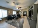 Spacious living room featuring vaulted ceilings, modern ceiling fans, and neutral toned walls at 4546 N 84Th Ln, Phoenix, AZ 85037