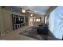 Inviting living room features tile flooring, large TV, and an open floor plan perfect for entertaining at 4546 N 84Th Ln, Phoenix, AZ 85037