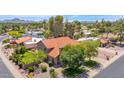 Expansive aerial view showcases the home's red tile roof, lush surroundings, and community at 5045 E Redfield Rd, Scottsdale, AZ 85254