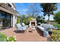 Inviting brick patio with comfortable seating and an outdoor fireplace at 5446 E Exeter Blvd, Phoenix, AZ 85018