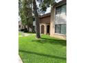 Exterior view of condo buildings with landscaped green space at 7126 N 19Th Ave # 103, Phoenix, AZ 85021