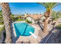 Backyard oasis featuring a sparkling pool, a diving board, and lush landscaping at 725 E Country Gables Dr, Phoenix, AZ 85022