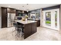 Modern kitchen with stainless steel appliances, granite countertops, and a center island with seating at 725 E Country Gables Dr, Phoenix, AZ 85022