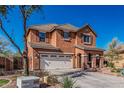 Two-story stucco home with a wide driveway, desert landscaping, tile roof, and a welcoming entrance at 7252 N 90Th Ln, Glendale, AZ 85305